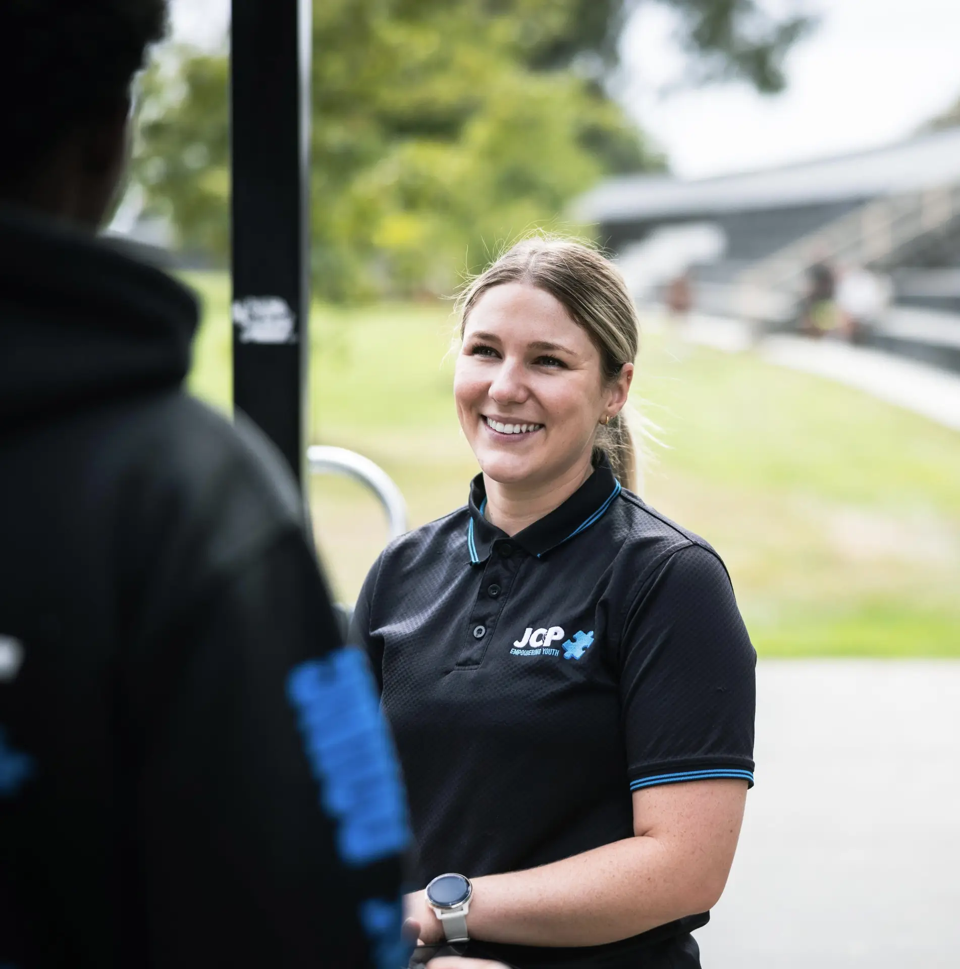 Sam, a JCP Youth Team Leader, in conversation with a colleague